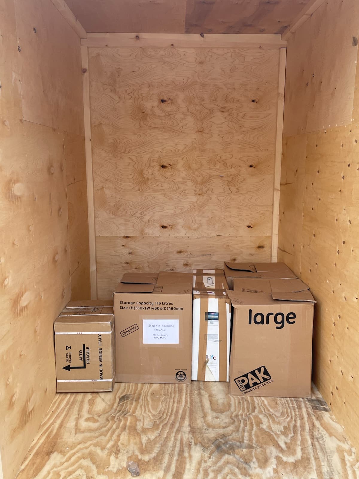 Labelled moving boxes loaded neatly at the back of an RMV storage container