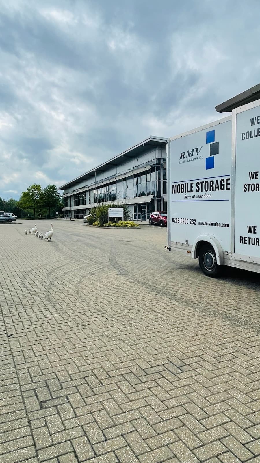 RMV Mobile Storage van parked outside a modern office building in a business park