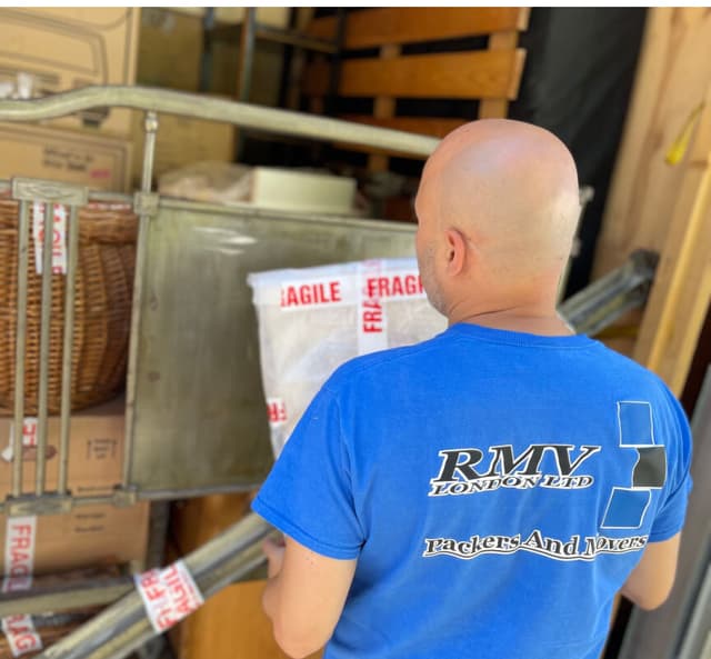 RMV mover loading wrapped belongings into a storage container