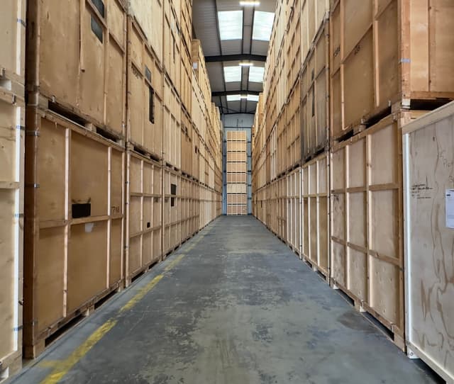 Rows of wooden storage containers inside the RMV warehouse in Rainham