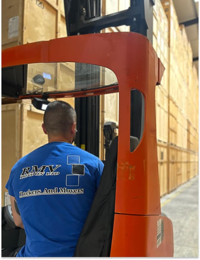 RMV team member moving storage containers with a forklift